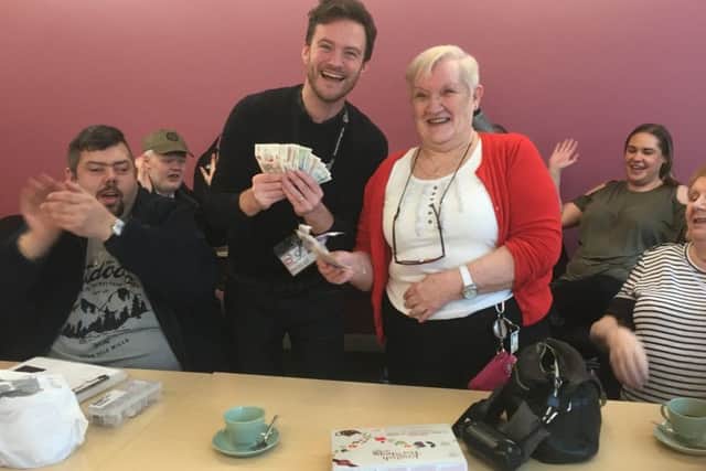 Liz Gore presenting £340 to Danny Du Heaume surrounded by members of the My Sight Bassetlaw social group.