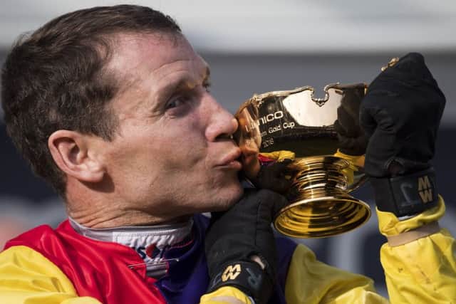 Champion jockey Richard Johnson kisses the Cheltenham Gold Cup after victory on Native River at last year's Festival. (PHOTO BY: Justin Setterfield/Getty Images)