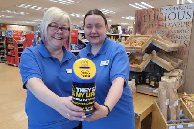 Helen Scase and Julie Smith with a collection tin for the Lincs & Notts Air Ambulance.