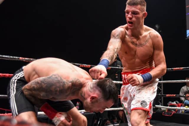 Ricardo Franco lands a blow as he towers over his opponent, James Connelly. (PHOTO BY: DN4 Photography)