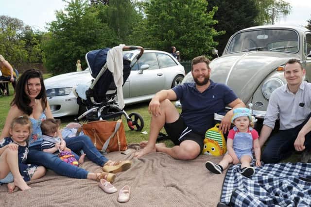 The Sheehans, from Sturton, and the Vaccaris, from Leverton, picnic alongside a '63 VW Beetle at the event.