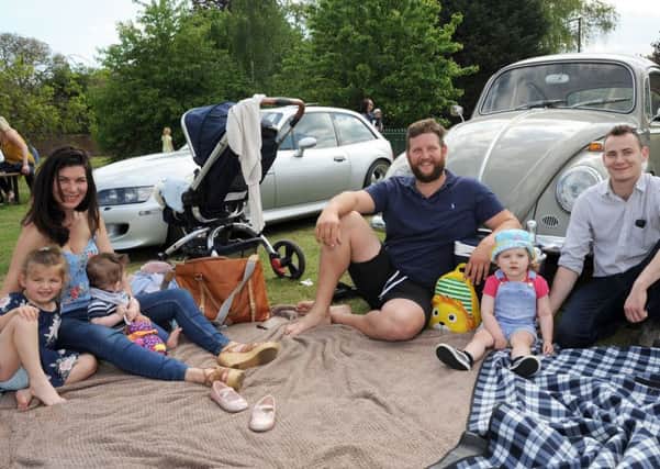 The Sheehans, from Sturton, and the Vaccaris, from Leverton, picnic alongside a '63 VW Beetle at the event.