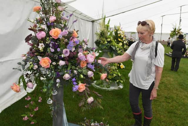 Lincolnshire Show. Lynne Kirkham looking at flower arrangements.