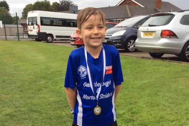 A wet and shivering Jackson Lawson-Haywood, who was the first primary school boy to finish.