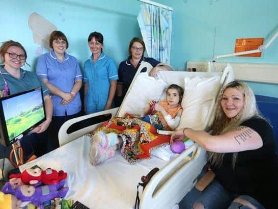 Kate Hewitt, 38 and her daughter Willow-Blue OShea, seven pictured with staff members on ward D34 at Queens Medical Centre .