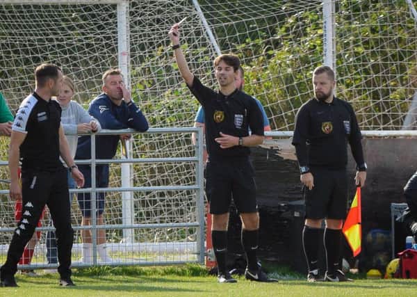 Furious Trinity boss Liam King is booked for protesting a late penalty decision.