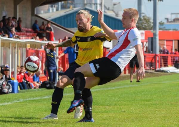Kingsley James in the thick of the action for Gainsborough Trinity at Witton Albion. (PHOTO BY: John Rudkin)