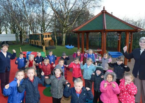 Pupils and staff at Prospect Hill Infant School celebtrate the opening of the new playground. Pictured with pupils is nursery teacher Julia Morris and chairman of governors Janet Pimperton.