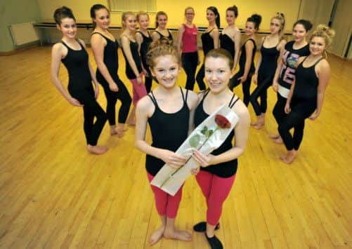 Guardian Rose to dance teacher Rebecca Doona from pupil Alix Poxon, Rebecca is pictured recieving her rose from Alix watched by members of the dance school (w130124-2a)