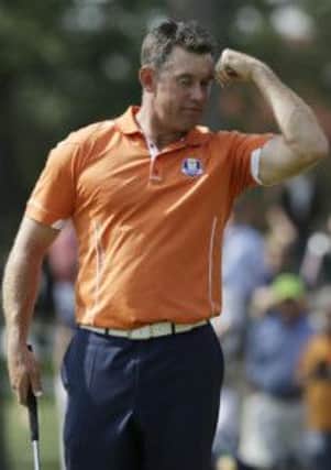 Europe's Lee Westwood flexes his muscle for captain Jose Maria Olazabal at the Ryder Cup PGA golf tournament Tuesday, Sept. 25, 2012, at the Medinah Country Club in Medinah, Ill. (AP Photo/David J. Phillip)