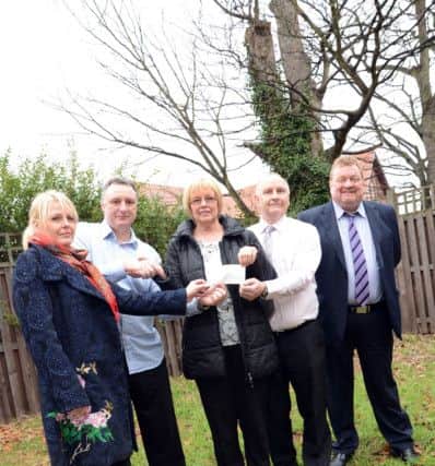 Eaton Production present a cheque for £12,500 to NORSACA for a sensory garden at Tall Trees Day Services in Retford w130208-3b