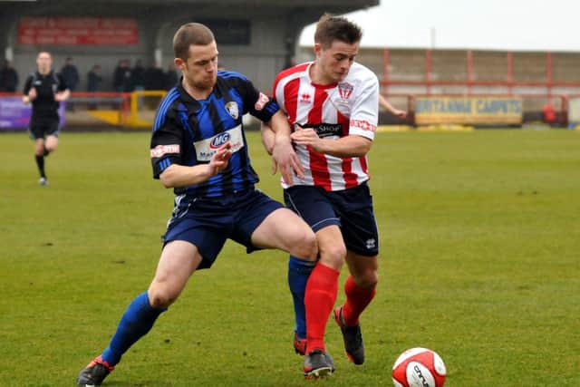 Ryan Clarke puts in a tackle at Witton