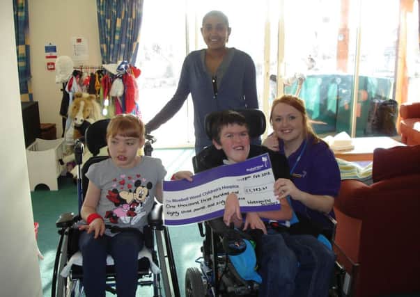 Children Emma-Louise and Oliver with Amy Wilson from Bluebell Wood Childrens Hospice accept the cheque from Deena Samachetty from Wake Smith LLP.