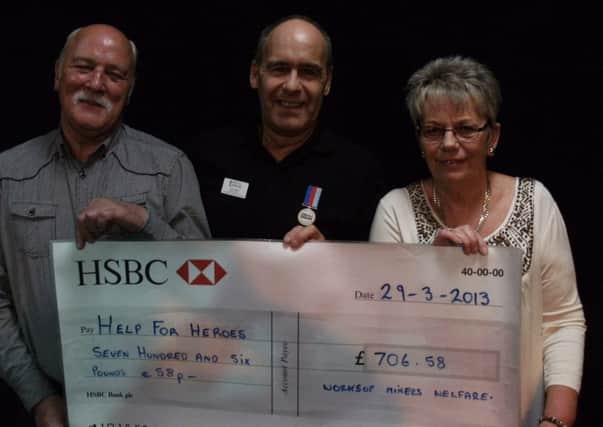 Tony Eaton of H4H pictured centre with Worksop Miners Welfare secretary Alec Woodward and treasurer Jan Sargison