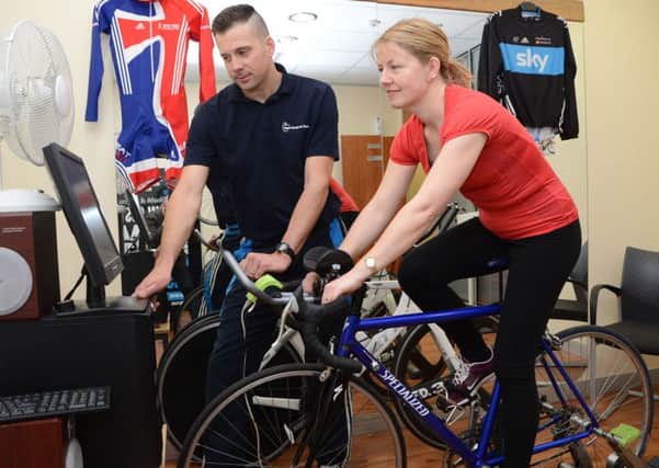 Andy Bishop from Apple Gym in Worksop and reporter Helen Johnston with a new cycling training bike G130322-5f