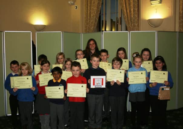 Coun Rebecca Leigh with pupils holding their certificates. Pictured centre is logo competition winner Niall Cartwright Goy holding his design.