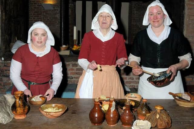 Lord Burgh's Retinue celebrated St George's Day at Gainsborough Old Hall, pictured are from left Liane Merrett, Veronica Fottit and Laura Clark in traditional costume, in the Kitchen of the Old hall. (G130422-2a)