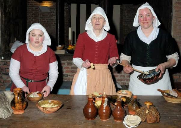 Lord Burgh's Retinue celebrated St George's Day at Gainsborough Old Hall, pictured are from left Liane Merrett, Veronica Fottit and Laura Clark in traditional costume, in the Kitchen of the Old hall. (G130422-2a)