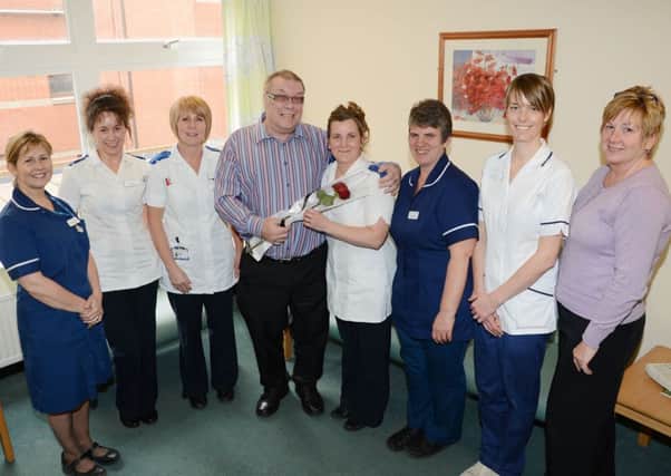 Graham Bacon presents the Guardian Rose to the staff on ward B5 at Bassetlaw Hospital G130419-4a