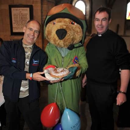 Cake sale at Priory Church for Help for Heroes charity, pictured with Hero bear are Father Spicer and Tony (w130504-3b)
