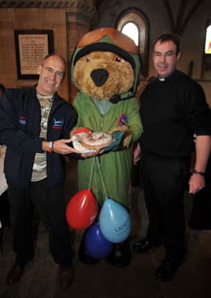 Cake sale at Priory Church for Help for Heroes charity, pictured with Hero bear are Father Spicer and Tony (w130504-3b)
