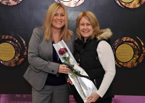 Guardian Rose presentation to Outwood Academy Valley Year 11 Learning Manager Stacey Anderson-Gilling, Stacey is pictured recieving her rose from Angela Templeton who nominated her for helping her Son Matthew reach his potential (w130523-1a)