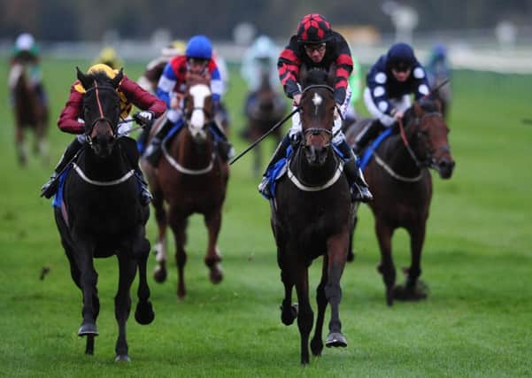 Carinya ridden by Tom Eaves (second right) comes home to win the B&M Installations Handicap ahead of Carragold ridden by Duran Fentiman (left) at Nottingham Racecourse. PRESS ASSOCIATION Photo. Picture date: Wednesday November 2, 2011. Photo credit should read: Andrew Matthews/PA Wire.