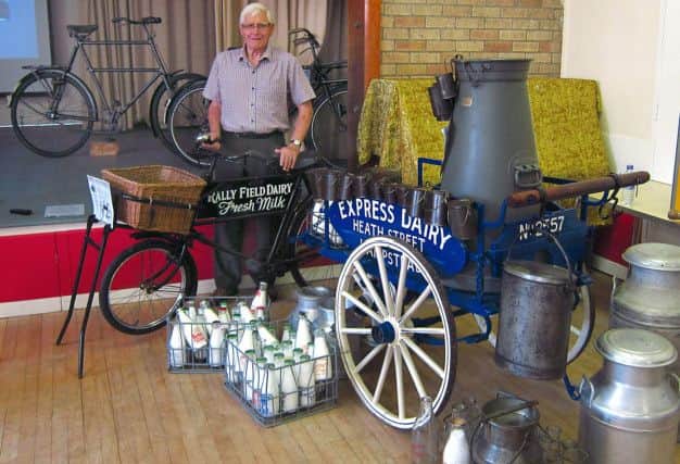 Ray Denton beside a display of equipment used from farm to doorstep delivery of the milking trade.