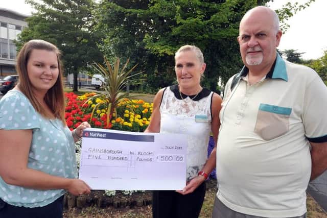 Cheque presentation to Gainsborough in Bloom, pictured from left town centre manager Samantha Dodd, Gainsborough in Bloom tresurer Anna Grieve and secretary Vaugh Hughes (w130724-2)