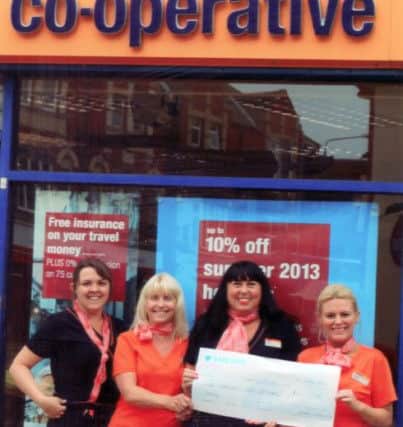 Co-Operative Travel Worksop hand over a cheque for the Bassetlaw Hospital Scanner appeal