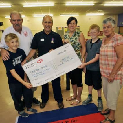 Carlton Youth Club have been fundraising for Help for Heroes, raising over £260. Pictured from left are Luke Darby, 12, Graham Cooper, Help for Heroes Tony Eaton, Tracey Cooper, Charlie Page, 12 and Maggie Cooper (w130731-1b)