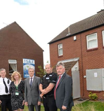 Boarded up crack house on Carnoustie in Worksop. Pictured are Chief Inspector Paul Murphy, Tammy Haywood, Coun Griff Wynne, Sgt Mark Goddard and Coun Glynn Gilfoyle G130810-2b