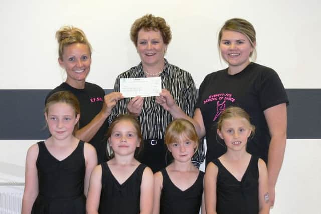District Coun Hazel Brand is pictured presenting a cheque for £200 to EFSD owner, Tracey Everett-Fox (left) and assistant, Lauren Riley, with pupils of one of the childrens dance classes.