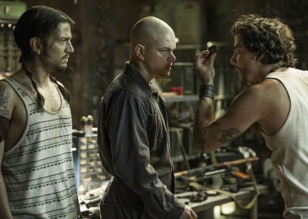 Max (MATT DAMON, center), Julio (DIEGO LUNA, left) and Spider (WAGNER MOURA) meet inside Spider's armory in Columbia Pictures' ELYSIUM.