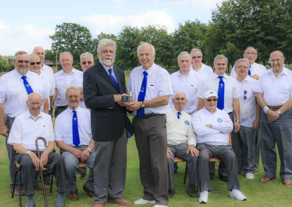 The trophy was presented to Brian Fox, this years vice captain, and captain of the gents team by chairman John Bishop, pictured in the blazer.