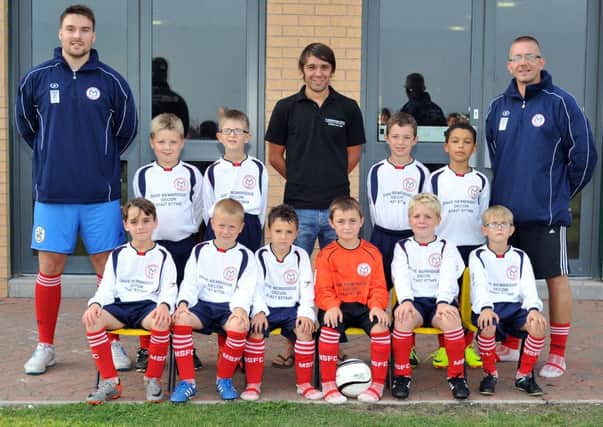 Marshalls U8's in their new kits, pictured are Marshalls Warriors pictured with sponsor Dave Bembridge Decor and coaches Nic Clover and Ben Spurr (w130905-2a)