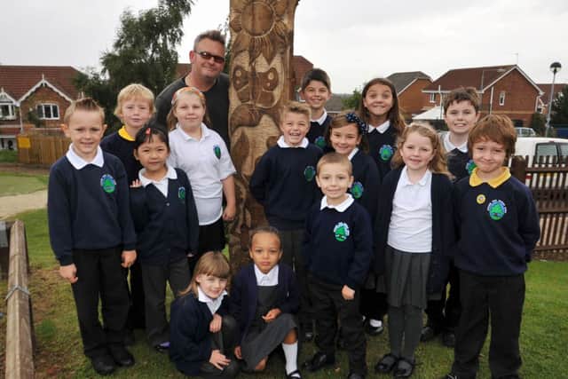 Sculptor Simon Kent has been working with children of Gateford Park Primary School to design a sculture for the school grounds, Simon is pictured with some of the children who helped to design the new feature (w130917-4)