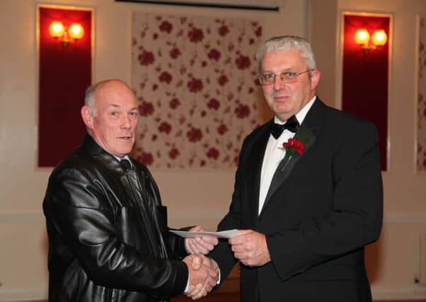 Sporting Club vice chaiman Nigel Taylor presenting a cheque to Steve McConville of Surton-by-Stowe Judo Club