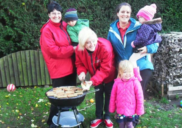 Children at Granby House Nursery, Carlton in Lindrick, enjoying hotdogs for Bonfire night.