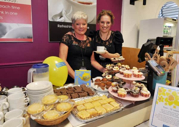 Oldrids department store have been raising money for Macmillan Cancer Care as part of the Blooming Great Tea Party, pictured from left are cafe manager Julie Burnett with Janet Bradley (w131106-2a)