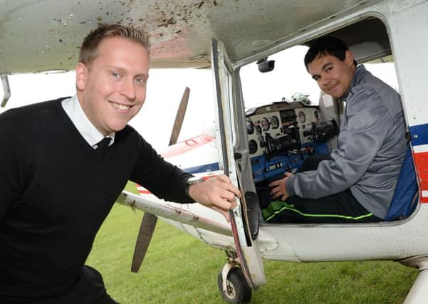 Aaron Barlow, 16, has gained his private pilot's licence at Sheffield Aero Club. Aaron is pictured with flight instructor Chris Black G131106-3b