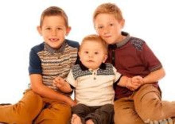 Jake is pictured with his brothers Joshua, 8, and Joel, 6.