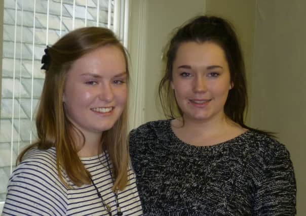 Mount St Marys College pupil, Lizzie Beard, presents a donation of £300 to former college pupil Evangeline Morrison (pictured left) to help her carry out her charity work.