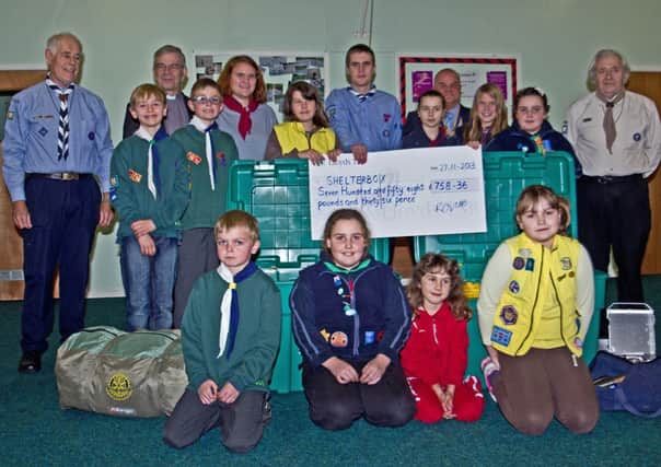 Rotary President Tony Airey and Canon Mike Cooney together with Leaders, Guides and Scouts from the Gainsborough area with their Shelterbox cheque.