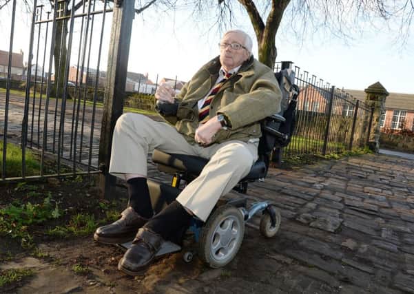 Fred Salmon is complaining about the cobbled paving in front of Priory Church in Worksop