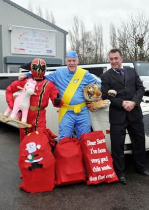 Red Road FM donating toys to Rotherham Hospital following their recent toy appeal, Cupid Carriages supplied the limo to deliver the toys to the hospital. Pictured from left are Red Radio support Barry Bull, presenter Ash Saywell and chauffeur Chris Sturman (w131218-2b)