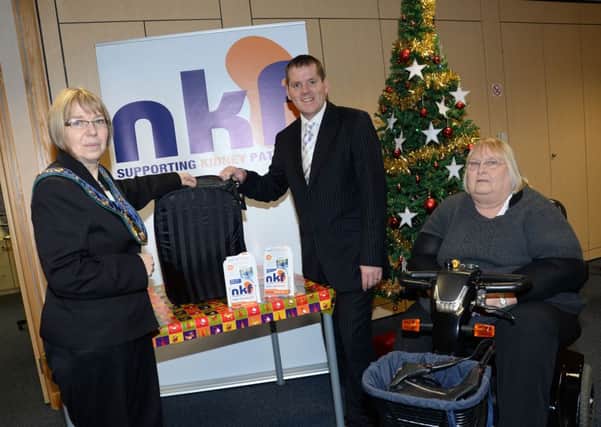 The Chairman of Bassetlaw District Council Sybil Fielding draws the winning tickets for the National Kidney Federation's grand draw. Also pictured are Head of Fundraising Peter Revell and Denny Abbott G131213-5a