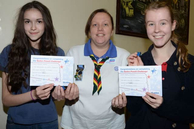 Shireoaks Girl Guides Emma White and Katie Lampkin are prsented with their Baden Powell Award by Worksop Division Commissioner Kirstie Pogson G131213-3a