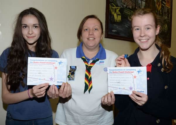 Shireoaks Girl Guides Emma White and Katie Lampkin are prsented with their Baden Powell Award by Worksop Division Commissioner Kirstie Pogson G131213-3a