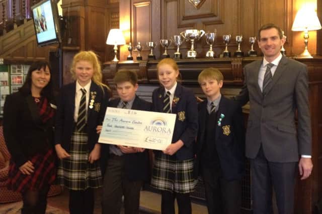 Worksop College Prep School Headmaster and students present charity donation to Aurora Wellbeing Centres.